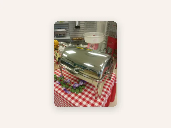 Stainless roll-top chafing dish on a buffet table